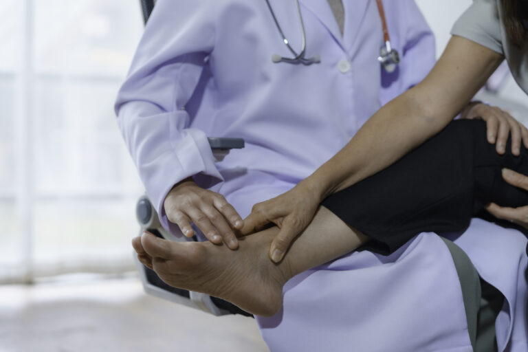 Doctor carefully examining a patient's foot, providing personalized healthcare and addressing potential foot and ankle problems in a medical setting