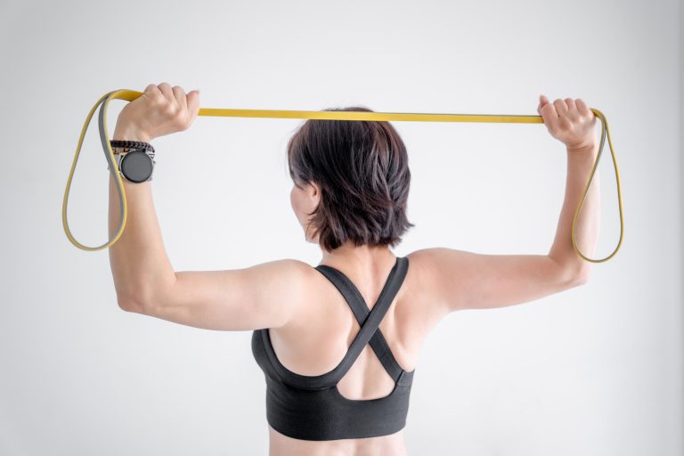 Sport Woman Exercises With Fitness Band, Close-Up Shot Of Hands